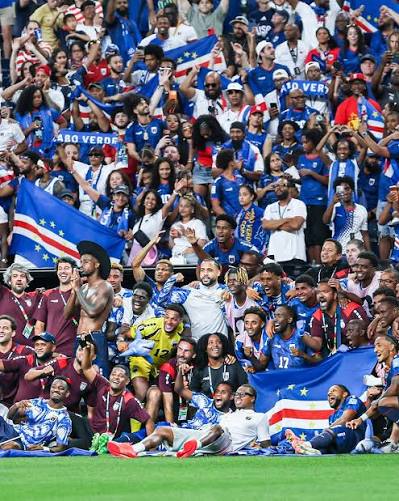 The Cape Verde national team celebrating with fans waving Cape Verde flags