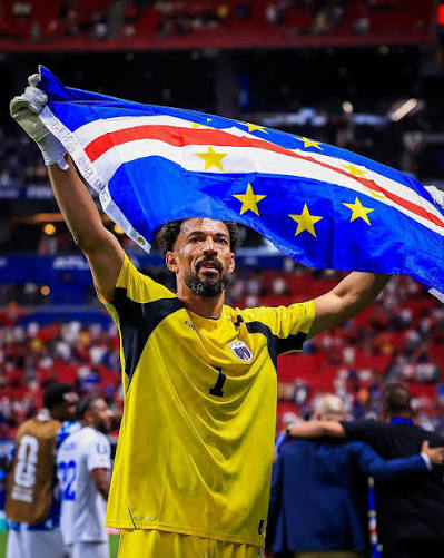 Vozinha, the Cape Verdean goalkeeper, holding the Cape Verde flag after the Spain match — the moment that traveled the world
